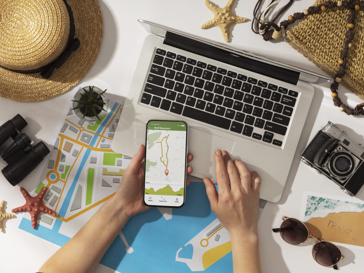 top view hand holding smartphone scaled Traveks